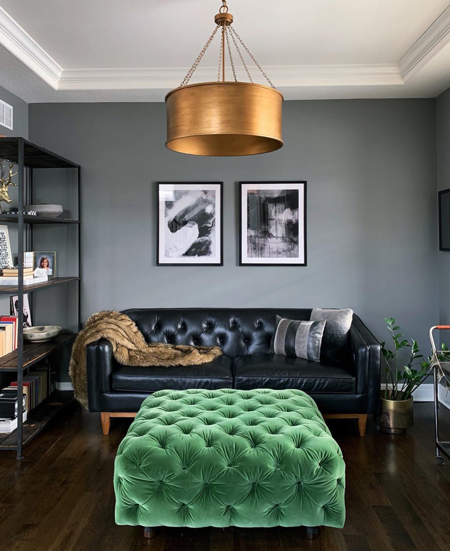 Article's black Alcott Leather sofa in a living room with a green emerald velvet pouf