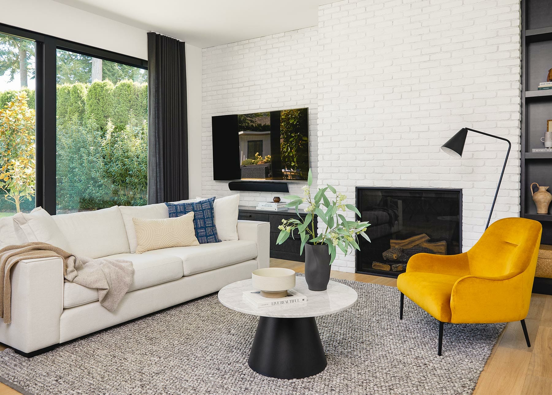 A minimalist living room is shown with Article's Embrace Chair in Heirloom Gold.