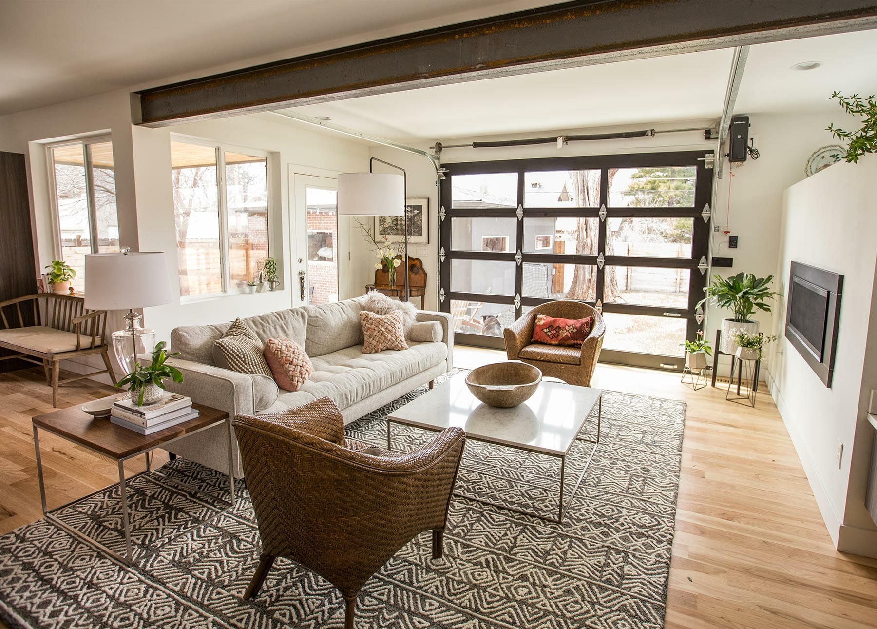 Blogger Flax and Twine's living room features a large patterned rug and a glass garage door window.
