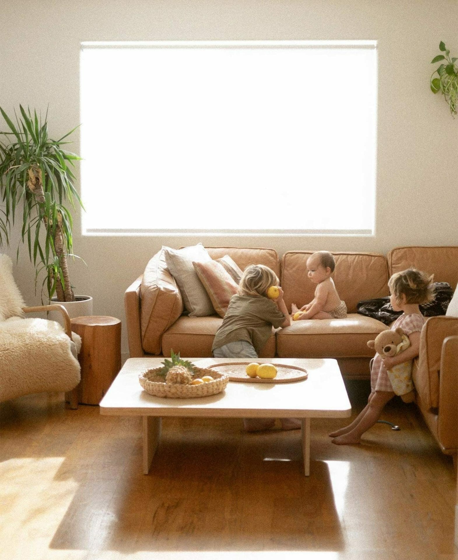 Yuna Leonard's bright space shows her children playing on the Timber Sectional from Article