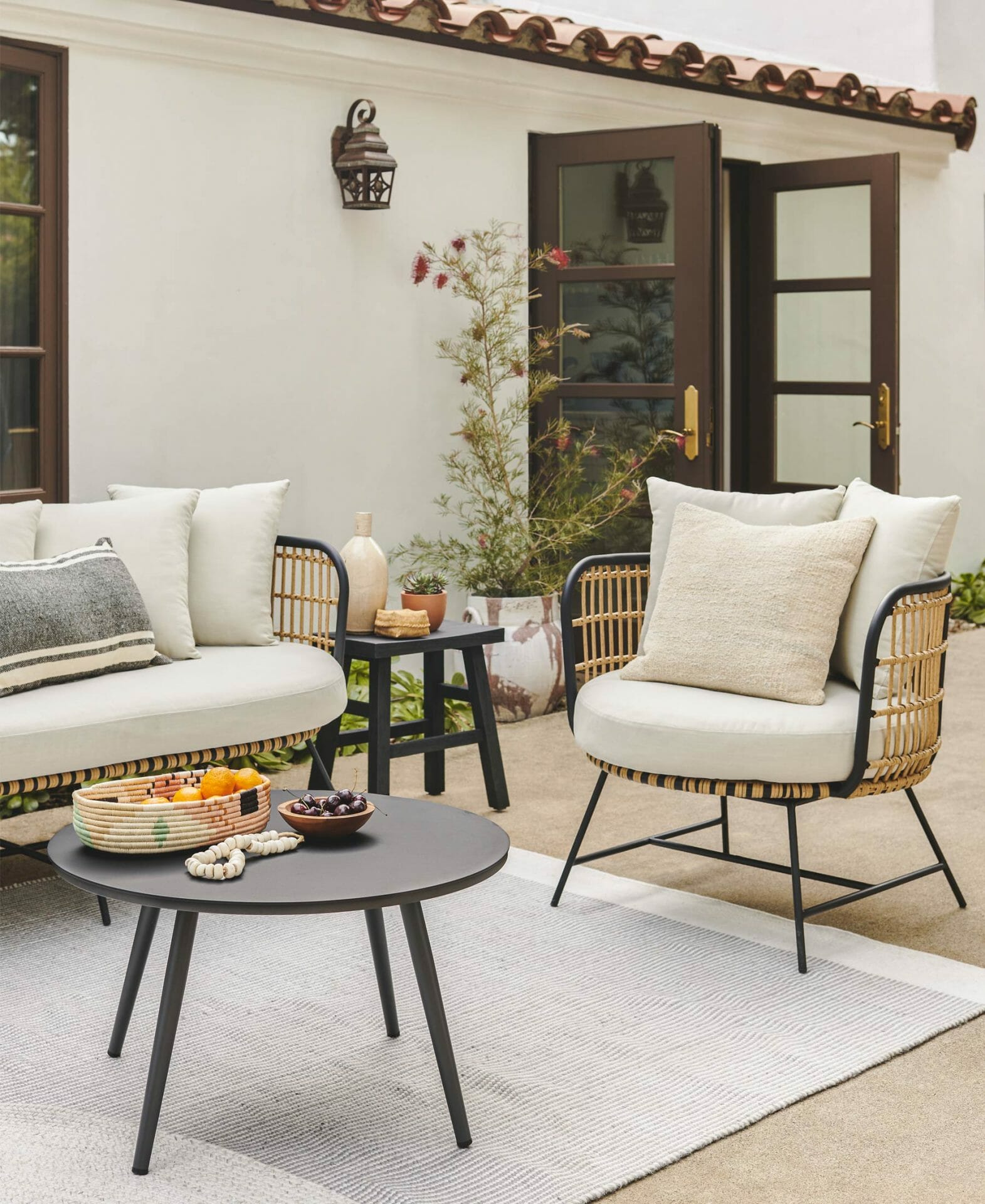 The Onya Set and Redondo Rug are shown next to a Spanish style villa.